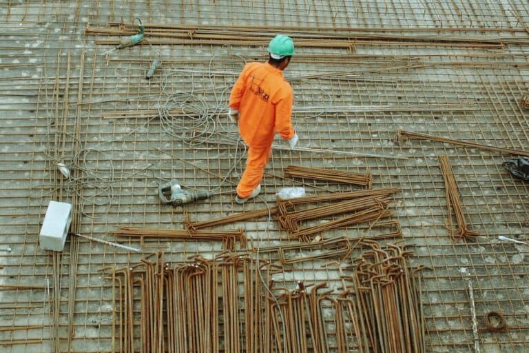 Construction worker on rebar at building site.